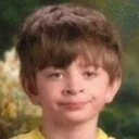 Young boy looking sideways with a skeptical and judgmental facial expression.