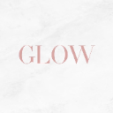 The word GLOW written in a soft pink serif font on a light marble background.