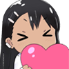 Nagatoro holding a large pink heart against her face with her eyes closed in a happy expression.