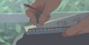 A hand holding a pencil and ruler to draw on a sketchbook in an anime style.