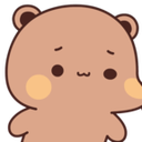 A brown bear cub looking down with a shy expression and pink blushing cheeks.