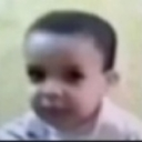 A blurry child looking at the camera with a skeptical and judging facial expression.