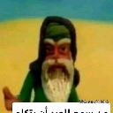 A claymation wizard with a long white beard and green hat looking directly at the camera with a suspicious expression.
