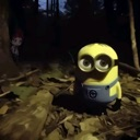 Minion standing in a dark forest looking suspicious.