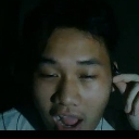 Man with a dazed and confused expression in a dimly lit room.