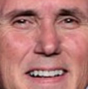 A man's lower face showing a tight, forced smile with teeth visible.