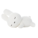 A white plush bunny sleeping peacefully on its side.