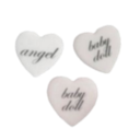 Three white heart-shaped candies with the words angel and babydoll written in elegant cursive text.