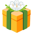 Gift box wrapped in green ribbon topped with a white flower.