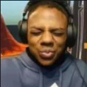 IShowSpeed making a skeptical face with pursed lips and closed eyes while wearing headphones.