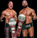 Dax Harwood and Cash Wheeler stand side-by-side holding their championship belts while smiling.