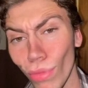 A young man making an exaggerated, dramatic pout with his lips.