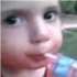 Child looking sideways with a skeptical expression while holding a juice box.