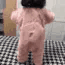 A pink blob character wiggling and dancing on a checkered surface.