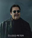 A man wearing dark sunglasses and a black coat looking directly at the camera with a serious expression.