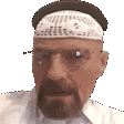 Walter White wearing a pork pie hat and glasses looking directly at the camera with a serious expression.