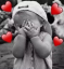A child covering their face with their hands, surrounded by four red hearts.