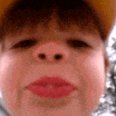 A child in a yellow hat blows a cloud of smoke toward the camera in a four-panel sequence.