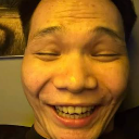 Man with a heavily distorted, wide-angle face showing a large, toothy grin.