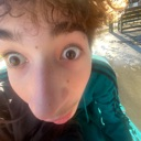 Person with wide eyes and a distorted face looking directly into the camera lens.