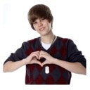 Justin Bieber making a heart shape with his hands.