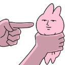 A pink rabbit with a smug, deadpan expression being held by a hand while another hand points at it.