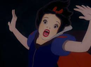 Snow White looking terrified with her hands raised in the dark.