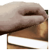 A human hand slowly descends to touch the top of a book in a four-frame sequence.
