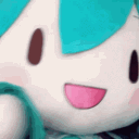 Hatsune Miku plushie smiling while rapidly moving closer to the camera.