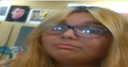 Person with glasses looking at the camera with a skeptical and unimpressed expression.