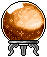 Crystal ball glowing with an orange light, resting on a silver stand.