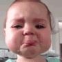 A toddler with a very sad, crying face and teary eyes.