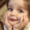 A toddler resting their chin on their hands while laughing and smiling in a four-frame sequence.