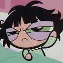Buttercup from The Powerpuff Girls looking annoyed with heavy bags under her eyes.